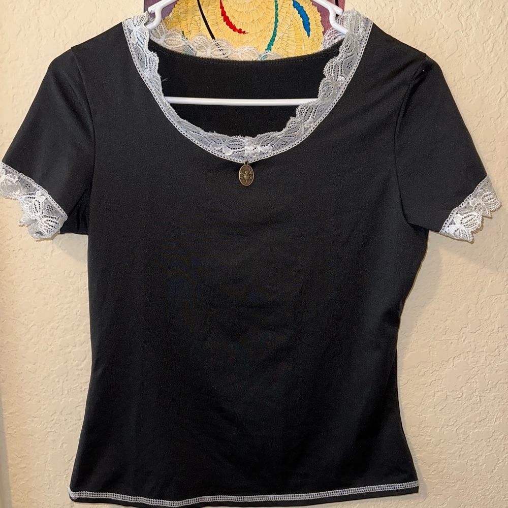 Black top with white lacy trim around collar and sleeves!
